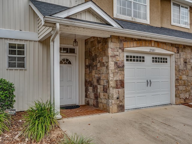 view of exterior entry with a garage