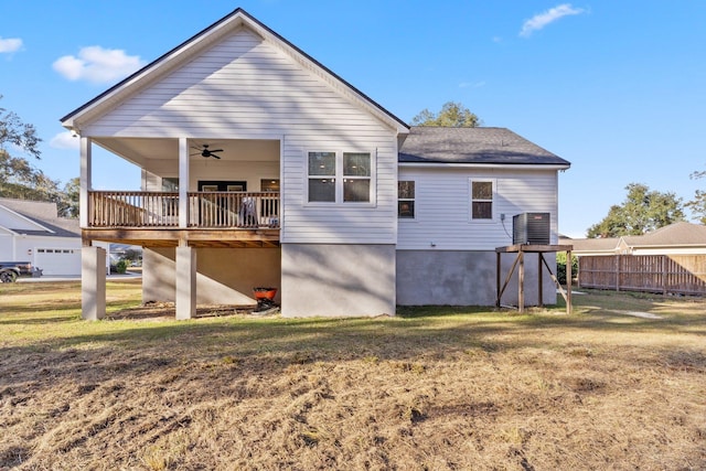 rear view of house with central AC, a yard, and ceiling fan