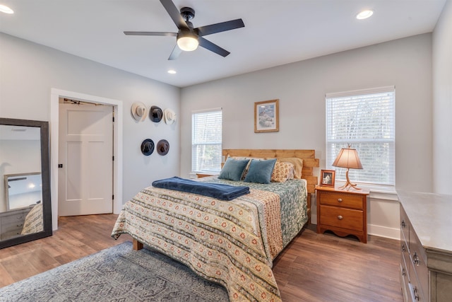 bedroom with ceiling fan and hardwood / wood-style flooring