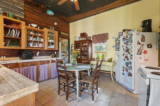 kitchen with light tile patterned flooring, white range with electric cooktop, ceiling fan, light countertops, and wood ceiling