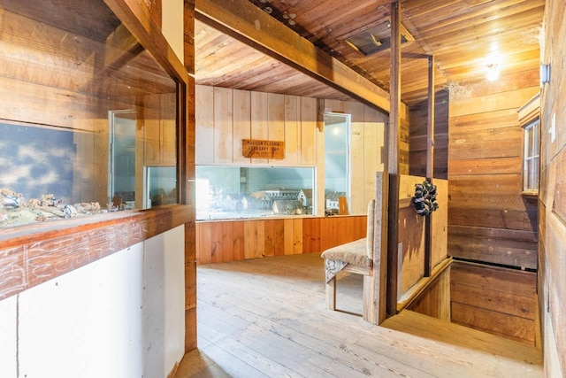 corridor featuring wood ceiling, wood walls, and hardwood / wood-style floors