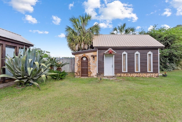 view of outbuilding with fence and an outbuilding