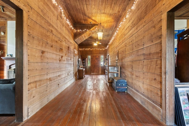 hallway with wooden walls, hardwood / wood-style flooring, and wooden ceiling