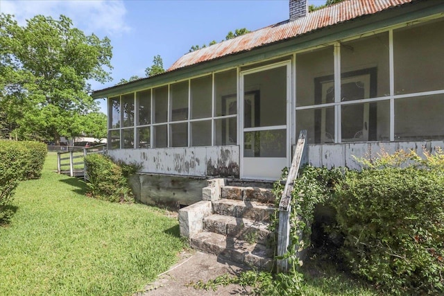 143 Washington Ave, Havana, FL 32333 - property entrance with metal roof, a yard, and a chimney