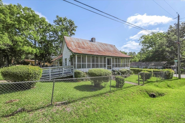 143 Washington Ave, Havana, FL 32333 - back of property featuring a sunroom, metal roof, and a chimney