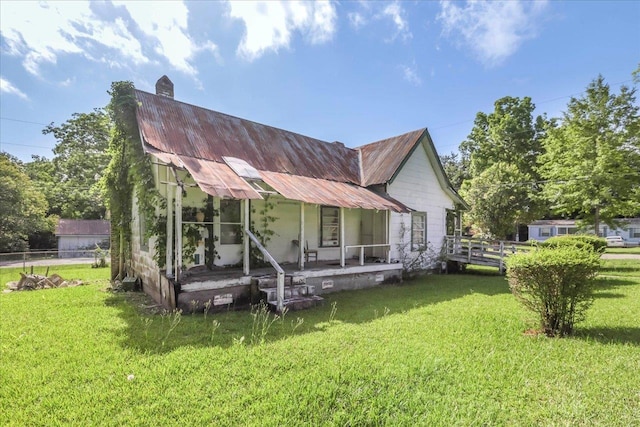 143 Washington Ave, Havana, FL 32333 - view of front facade featuring a porch, metal roof, and a chimney