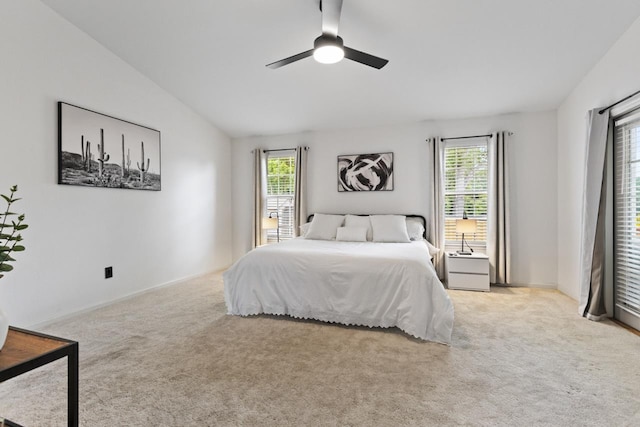 bedroom with ceiling fan, multiple windows, and carpet