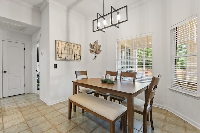 dining area featuring a chandelier, baseboards, visible vents, and ornamental molding