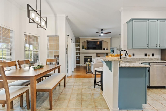 kitchen with a ceiling fan, ornamental molding, a sink, and dishwasher