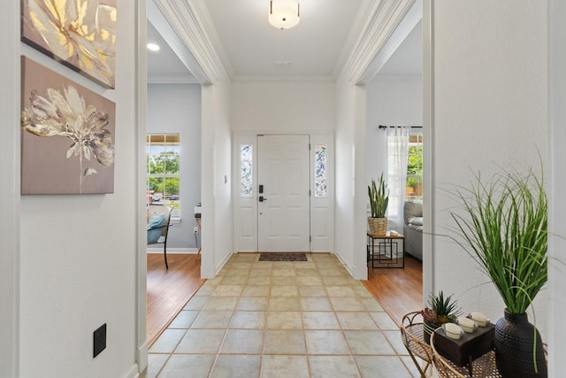 foyer entrance featuring ornamental molding