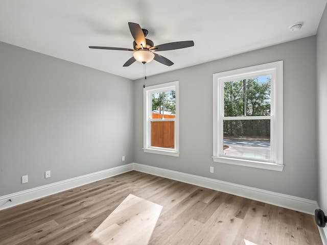 65 Sioux Trl, Crawfordville, FL 32327 - empty room with wood finished floors, baseboards, a ceiling fan, and a smoke detector