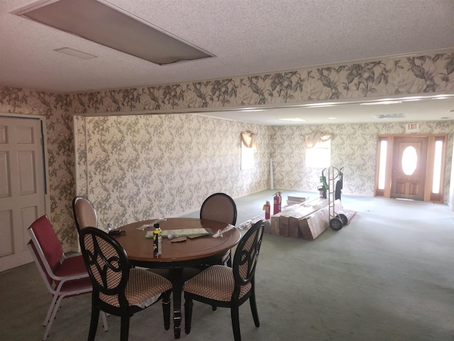 dining area with carpet flooring and a textured ceiling