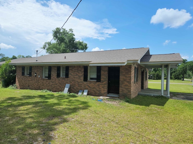 rear view of property with a lawn