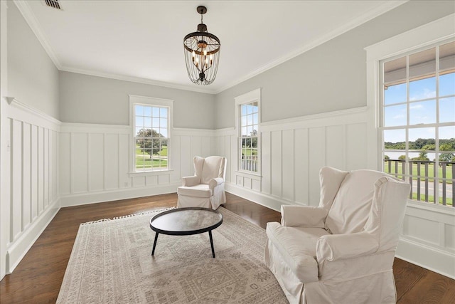 4640 Grove Park Dr, Tallahassee, FL 32311 - living area featuring a wainscoted wall, dark wood-style floors, a chandelier, a decorative wall, and a water view
