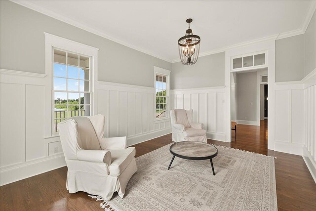 4640 Grove Park Dr, Tallahassee, FL 32311 - living area featuring a decorative wall, a chandelier, a wainscoted wall, dark wood finished floors, and ornamental molding