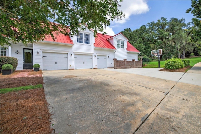 4640 Grove Park Dr, Tallahassee, FL 32311 - view of front facade featuring concrete driveway, a metal roof, and a garage