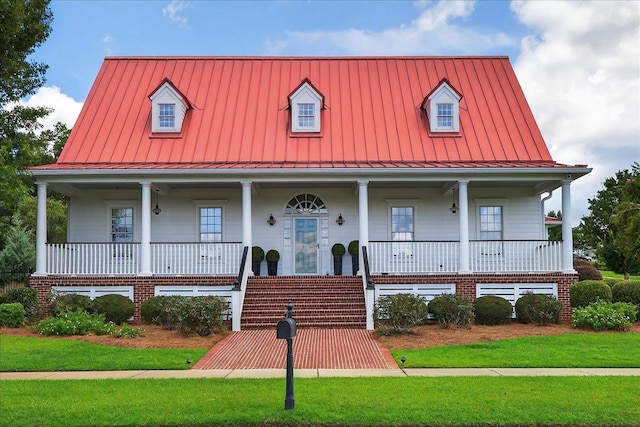 4640 Grove Park Dr, Tallahassee, FL 32311 - view of front of property featuring a standing seam roof, covered porch, and a front lawn