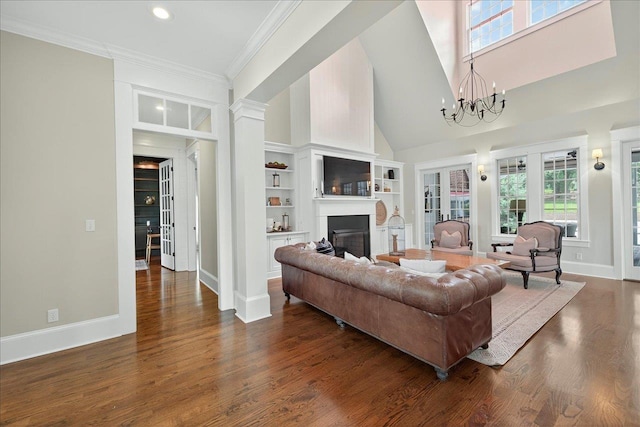 4640 Grove Park Dr, Tallahassee, FL 32311 - living room with a fireplace, dark wood finished floors, a towering ceiling, ornamental molding, and recessed lighting