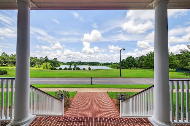 4640 Grove Park Dr, Tallahassee, FL 32311 - covered porch featuring a water view, view of golf course, and view of scattered trees