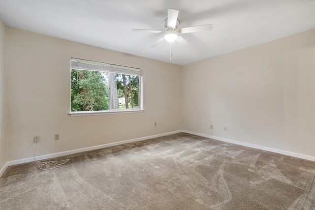 carpeted empty room featuring ceiling fan