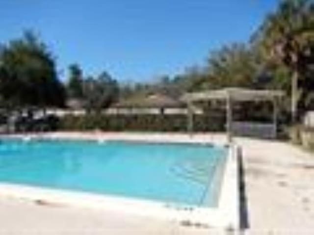 view of pool featuring a beach view