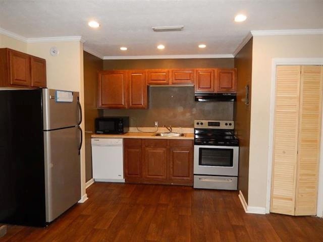 kitchen with white appliances, crown molding, sink, and dark hardwood / wood-style flooring