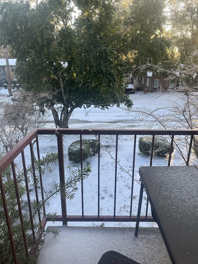 view of snow covered back of property