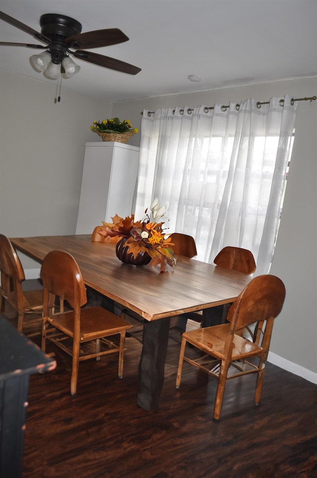 dining space featuring dark wood-type flooring and ceiling fan