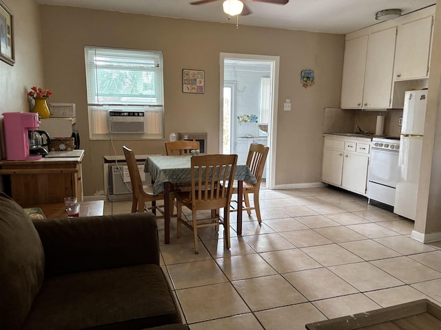 dining room featuring cooling unit, ceiling fan, light tile patterned floors, and a wall mounted air conditioner