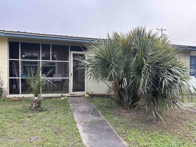 doorway to property with a yard