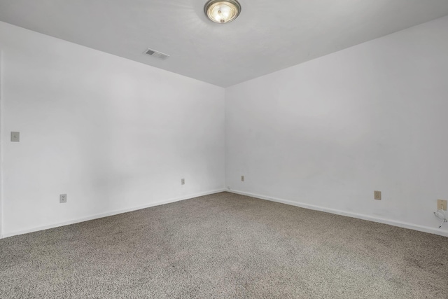 carpeted spare room with baseboards and visible vents