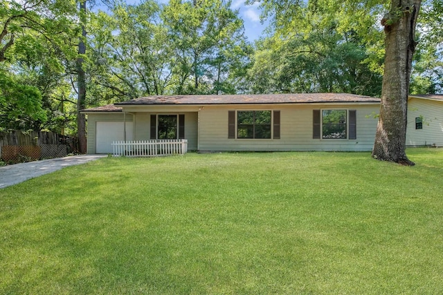 single story home featuring concrete driveway, fence, a front lawn, and a garage