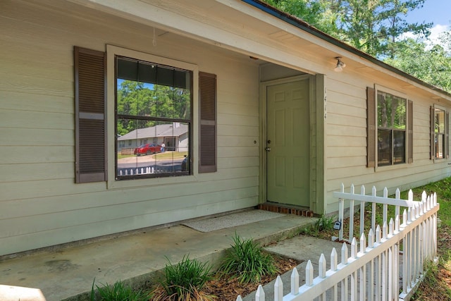 view of exterior entry with fence