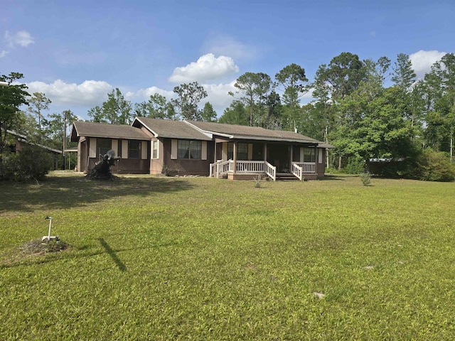 3232 Loren Henderson Rd, Perry, FL 32347 - rear view of property featuring a sunroom and a yard