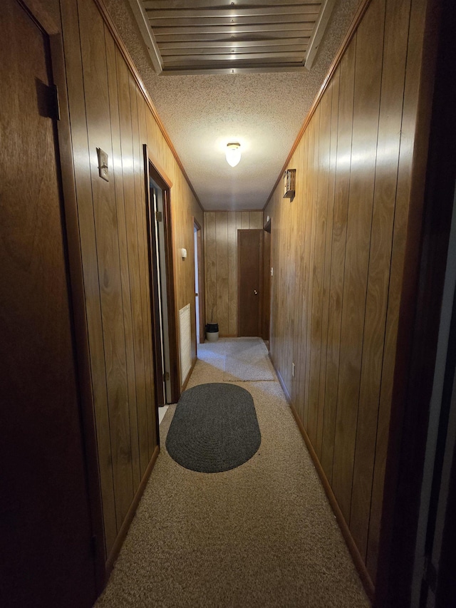 3232 Loren Henderson Rd, Perry, FL 32347 - corridor featuring wood walls, ornamental molding, light carpet, visible vents, and a textured ceiling