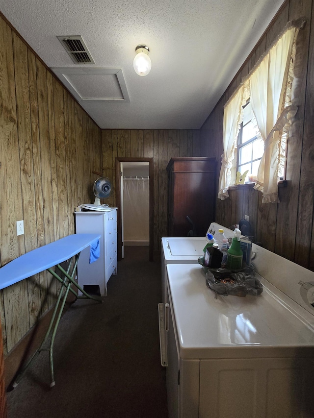 3232 Loren Henderson Rd, Perry, FL 32347 - clothes washing area with dark carpet, a textured ceiling, visible vents, wooden walls, and laundry area