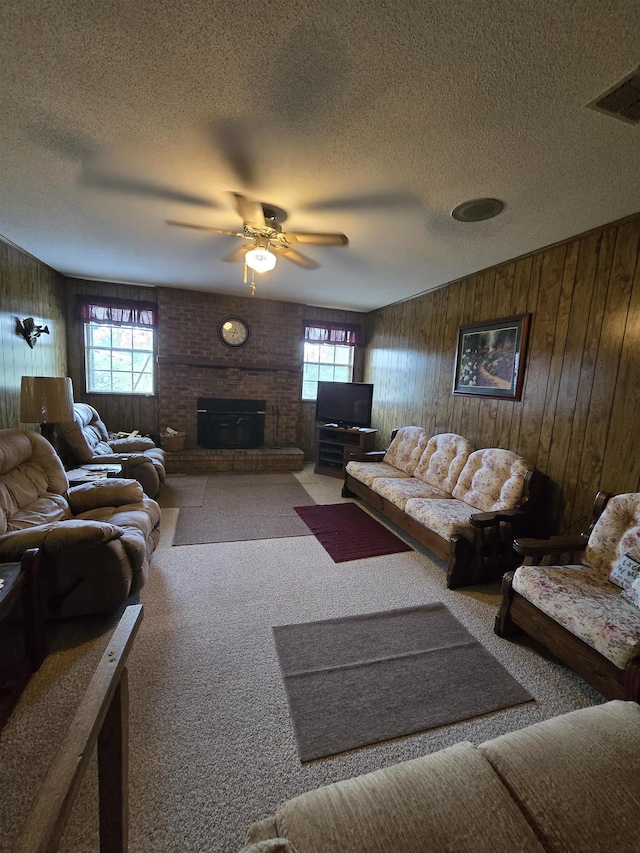 3232 Loren Henderson Rd, Perry, FL 32347 - carpeted living area with a brick fireplace, a textured ceiling, a ceiling fan, and a healthy amount of sunlight