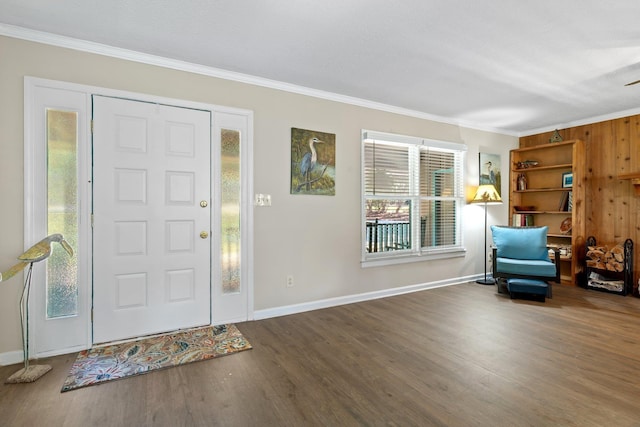 foyer entrance featuring baseboards, ornamental molding, and wood finished floors