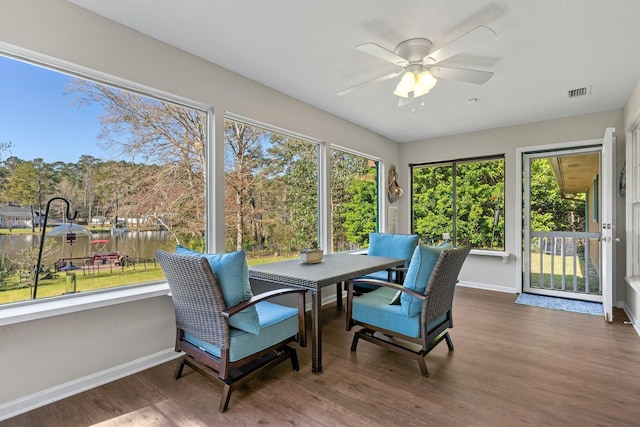 sunroom / solarium with plenty of natural light, baseboards, visible vents, and wood finished floors