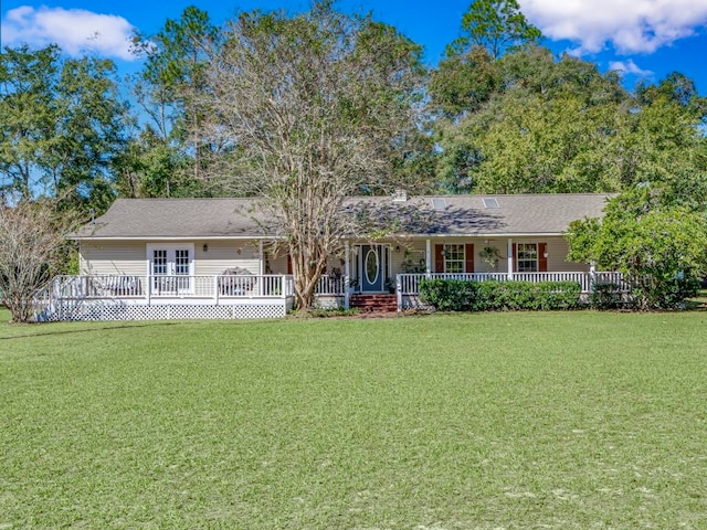 single story home with a front yard and covered porch