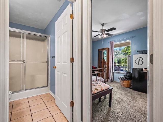 bathroom with an enclosed shower, tile patterned flooring, and ceiling fan