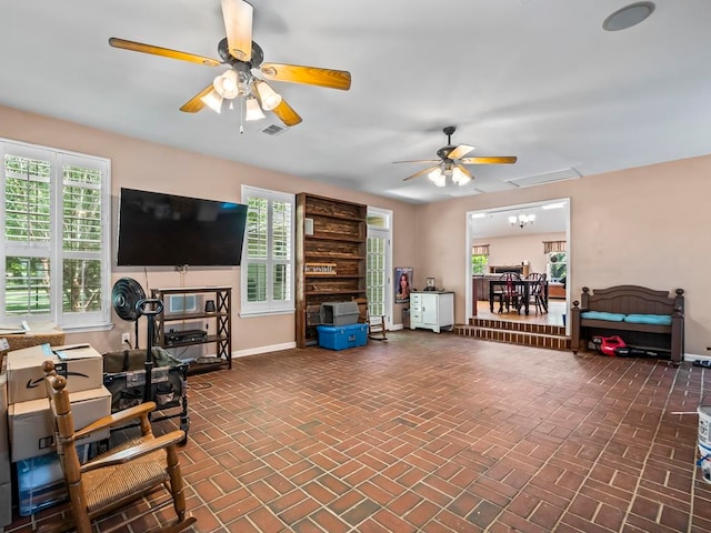 living room with a wealth of natural light and ceiling fan