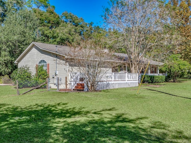 rear view of property featuring a lawn