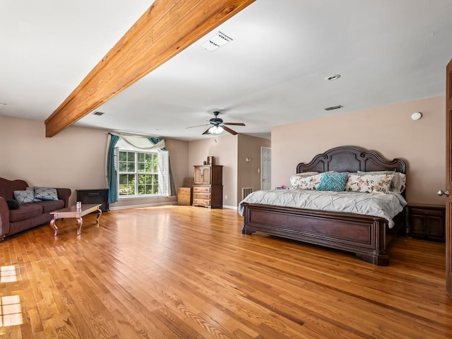 bedroom with beamed ceiling, light hardwood / wood-style floors, and ceiling fan