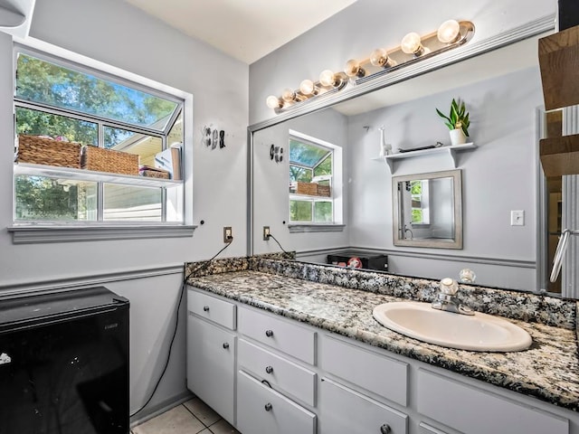 bathroom featuring tile patterned flooring and vanity