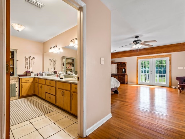 bathroom with french doors, wood-type flooring, ceiling fan, and vanity