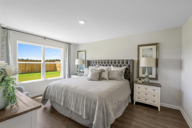 bedroom with dark hardwood / wood-style floors