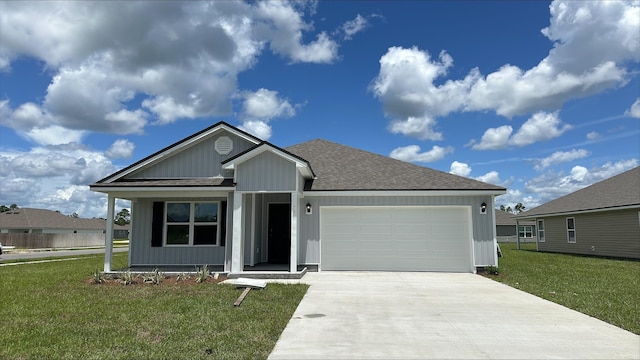 view of front of property featuring a front lawn and a garage