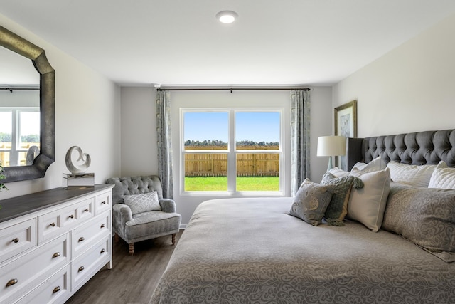 bedroom featuring dark hardwood / wood-style flooring and multiple windows