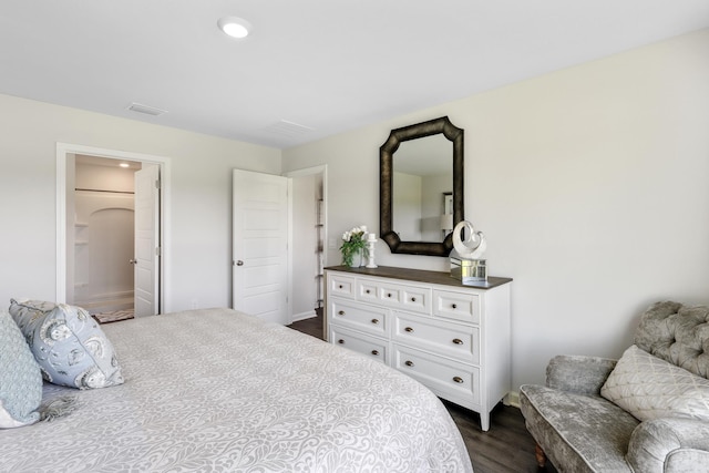 bedroom featuring dark hardwood / wood-style flooring and ensuite bath